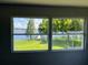 Scenic view of the lake and pier through double windows, bringing the outdoors in at 14330 Ellerbee St, Winter Garden, FL 34787