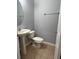 Cozy bathroom with a tiled floor, toilet, and sink at 14531 Pleach St, Winter Garden, FL 34787