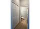 Hallway featuring a small guest bathroom with tiled floors at 14531 Pleach St, Winter Garden, FL 34787