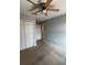Bedroom featuring carpeted floors, double-door closet, and a ceiling fan for added comfort at 14531 Pleach St, Winter Garden, FL 34787