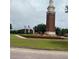 Picturesque community landmark featuring manicured lawn, decorative flowerbeds, and an American flag at 14531 Pleach St, Winter Garden, FL 34787