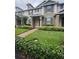Charming townhome featuring a well-maintained lawn and lovely landscaping at 14531 Pleach St, Winter Garden, FL 34787