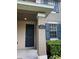 Charming townhome with green bushes and blue shutters at 14531 Pleach St, Winter Garden, FL 34787