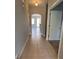 Hallway with tiled floors that leads to the kitchen and living room at 14531 Pleach St, Winter Garden, FL 34787