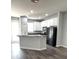 Charming kitchen featuring white cabinets and stainless steel appliances at 14531 Pleach St, Winter Garden, FL 34787