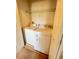 Convenient laundry room features a washer, dryer, and a wire shelf for optimal storage solutions at 14531 Pleach St, Winter Garden, FL 34787