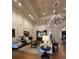 Spacious lounge area with elegant seating, high ceilings, and decorative chandelier at 14531 Pleach St, Winter Garden, FL 34787
