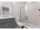 Well-lit bathroom with gray vanity, quartz countertop, toilet, and walk-in shower with glass door at 15358 Arcadia Bluff Loop, Winter Garden, FL 34787