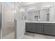 Modern bathroom featuring double sink vanity and glass enclosed shower with neutral color palette at 15358 Arcadia Bluff Loop, Winter Garden, FL 34787