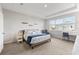 Comfortable bedroom with a tray ceiling, large window, and neutral carpet at 15358 Arcadia Bluff Loop, Winter Garden, FL 34787