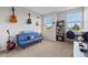 Inviting bedroom with blue futon, guitars, natural light, and versatile decor at 15358 Arcadia Bluff Loop, Winter Garden, FL 34787