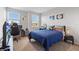 Comfortable bedroom featuring ample sunlight, desk space, and a cozy blue bed at 15358 Arcadia Bluff Loop, Winter Garden, FL 34787