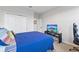 Bright bedroom with a blue bed and tv with ocean view at 15358 Arcadia Bluff Loop, Winter Garden, FL 34787