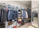 Spacious walk-in closet featuring ample shelving, hanging rods, and a full length mirror at 15358 Arcadia Bluff Loop, Winter Garden, FL 34787