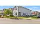 Charming two-story home showcasing manicured landscaping, a black fence, and a corner lot at 15358 Arcadia Bluff Loop, Winter Garden, FL 34787