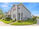 Charming two-story home featuring light gray stucco, a black fence, and manicured landscaping at 15358 Arcadia Bluff Loop, Winter Garden, FL 34787