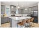 Modern kitchen with gray cabinets, quartz countertops, stainless steel appliances, and island seating at 15358 Arcadia Bluff Loop, Winter Garden, FL 34787