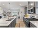 Spacious kitchen with an island and breakfast bar, stainless steel appliances and wood flooring at 15358 Arcadia Bluff Loop, Winter Garden, FL 34787