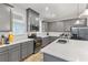 Modern kitchen with gray cabinets, quartz countertops, stainless steel appliances, and tile backsplash at 15358 Arcadia Bluff Loop, Winter Garden, FL 34787