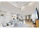 Bright living room with a soaring ceiling, seamlessly connecting the kitchen and the upstairs loft area at 15358 Arcadia Bluff Loop, Winter Garden, FL 34787