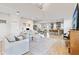 Bright, open-concept living room showcases modern decor and smooth transition to kitchen and dining areas at 15358 Arcadia Bluff Loop, Winter Garden, FL 34787