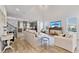 Bright living room with wood-look tile flooring and views of the kitchen at 15358 Arcadia Bluff Loop, Winter Garden, FL 34787