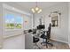 Comfortable home office featuring two desks, chandelier lighting, and large windows at 15358 Arcadia Bluff Loop, Winter Garden, FL 34787