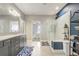 This bathroom offers a glass-enclosed shower, double sink vanity, and modern fixtures at 15378 Gilligan Ct, Winter Garden, FL 34787