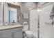 Modern bathroom featuring a granite countertop vanity, toilet, and a glass-enclosed shower for a spa-like experience at 15378 Gilligan Ct, Winter Garden, FL 34787