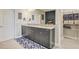 This bathroom has a double sink vanity, decorative mirror, and a tiled floor at 15378 Gilligan Ct, Winter Garden, FL 34787
