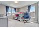 Bedroom with bunk beds, natural light, and a hanging chair, creating a cozy and inviting space at 15378 Gilligan Ct, Winter Garden, FL 34787