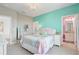This bedroom is painted in pastel colors with a chandelier and ensuite bathroom at 15378 Gilligan Ct, Winter Garden, FL 34787