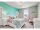 This bedroom offers colorful decor, a chandelier, and a cozy sitting area at 15378 Gilligan Ct, Winter Garden, FL 34787