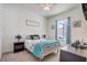 Inviting bedroom with a comfortable bed, blue accents, and a ceiling fan for a relaxing atmosphere at 15378 Gilligan Ct, Winter Garden, FL 34787