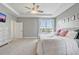 Bedroom showcasing tray ceiling, ceiling fan, and a large window that provides abundant natural light at 15378 Gilligan Ct, Winter Garden, FL 34787