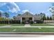 Charming clubhouse with a well-maintained lawn and manicured hedges at 15378 Gilligan Ct, Winter Garden, FL 34787