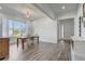 Formal dining room featuring wood floors, large windows, and stylish decor, ideal for Gathering gatherings at 15378 Gilligan Ct, Winter Garden, FL 34787