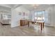 Cozy dining area with wood floors, a modern light fixture, and seamless flow to the living area for entertaining at 15378 Gilligan Ct, Winter Garden, FL 34787