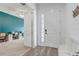 Inviting entryway featuring a white door, wood-look tile flooring and views into the office at 15378 Gilligan Ct, Winter Garden, FL 34787