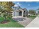 Charming two-story home featuring stone accents, manicured landscaping, and a brick paved drive leading to the garage at 15378 Gilligan Ct, Winter Garden, FL 34787