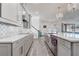 Gourmet kitchen featuring a large island, stainless steel appliances, light gray cabinetry, and a designer tile backsplash at 15378 Gilligan Ct, Winter Garden, FL 34787
