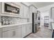 Well-appointed kitchen with stainless steel appliances, stylish tile backsplash, and light gray cabinets at 15378 Gilligan Ct, Winter Garden, FL 34787