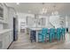 Bright, modern kitchen with a large island, stylish chandeliers, stainless steel appliances, and wood-look tile flooring at 15378 Gilligan Ct, Winter Garden, FL 34787