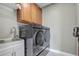 This laundry room includes a modern washer and dryer, a sink, and a storage cabinet at 15378 Gilligan Ct, Winter Garden, FL 34787