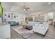 Bright living room showcases a colorful rug, comfortable seating, and an open layout leading to the kitchen at 15378 Gilligan Ct, Winter Garden, FL 34787