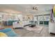 Open living area with a large sectional, view of pool area, and easy access to the adjacent kitchen and dining spaces at 15378 Gilligan Ct, Winter Garden, FL 34787