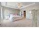 Serene main bedroom featuring a tray ceiling, calming decor, and an en suite bathroom at 15378 Gilligan Ct, Winter Garden, FL 34787