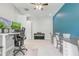 Spacious office boasting tandem desk layout with a piano, ceiling fan and ample lighting at 15378 Gilligan Ct, Winter Garden, FL 34787