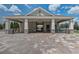 Open-air pavilion with picnic tables and stone-clad supports on a brick paver patio at 15378 Gilligan Ct, Winter Garden, FL 34787