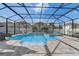 Sparkling pool featuring a slide and waterfall feature within a screened enclosure, offering a private backyard oasis at 15378 Gilligan Ct, Winter Garden, FL 34787
